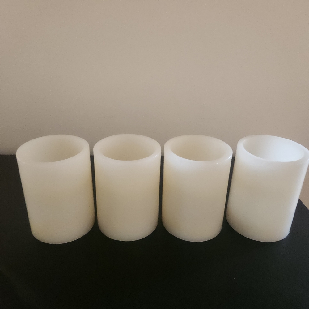 4 flameless wax pillar candles.  Battery powered unscented